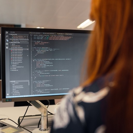 A woman working on computer code