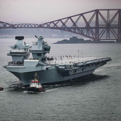 Britain’s newest aircraft carrier, The Prince of Wales, pictured sailing from Rosyth Dockyard for the very first time. Eight years after her steel was cut, the 65000-tonne warship heads under the iconic Fourth Bridge to begin her initial sea trials.